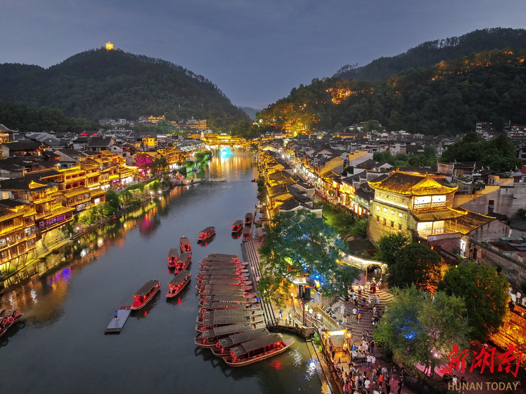 鳳凰古城流光溢彩，游人如織。