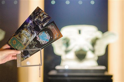 網(wǎng)友手持聯(lián)名款紀(jì)念門票及聯(lián)名款透卡與三星堆文物合影